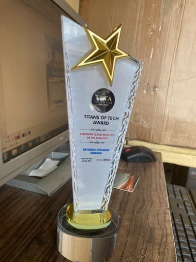The Titans of Tech award plaque, a glass trophy topped with a gold star