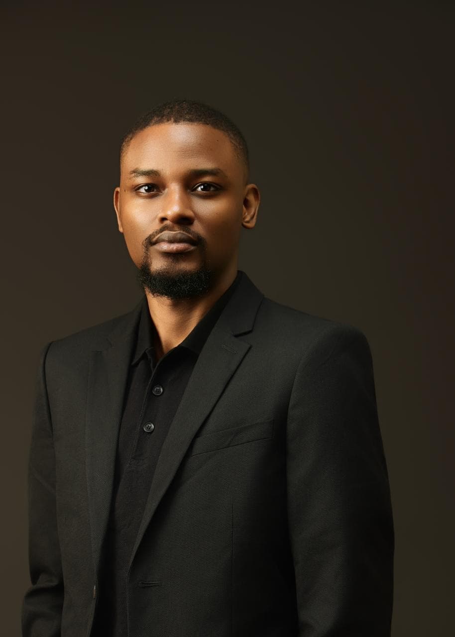 Kehinde Abiuwa in a dark suit jacket